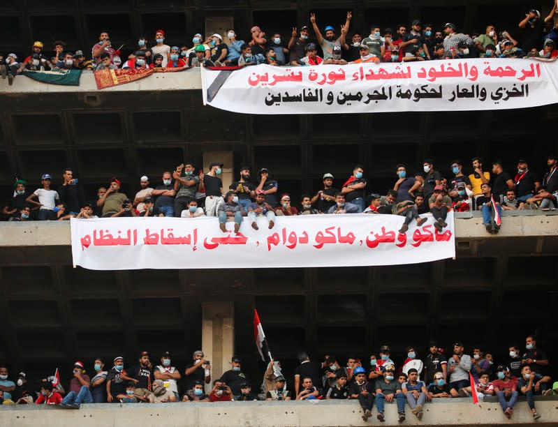 Demonstrators display a banner during a protest over corruption, lack of jobs, and poor services, in Baghdad