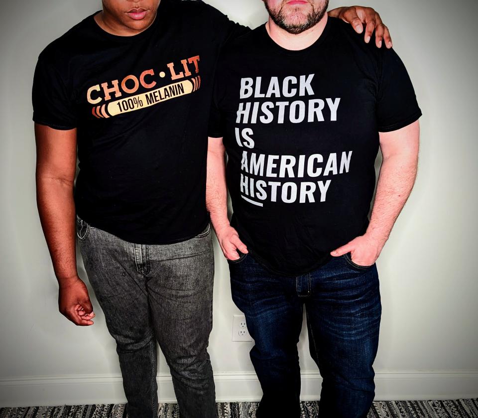 Cameron Smith, right, and his foster son, wearing T-shirts during Black History Month. The boy's face is partially obscured due to concerns over privacy and public safety since he is in the foster care system.