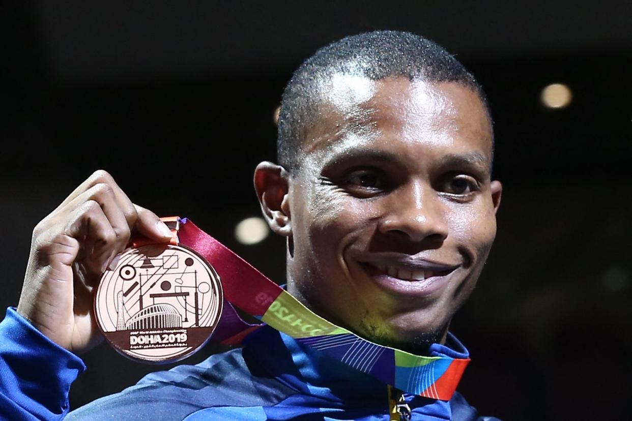In this Oct. 2, 2019 photo bronze medallist Ecuador's Alex Quinonez poses on the podium during the medal ceremony for the Men's 200-meter at the 2019 IAAF World Athletics Championships at the Khalifa International stadium in Doha, Qatar.