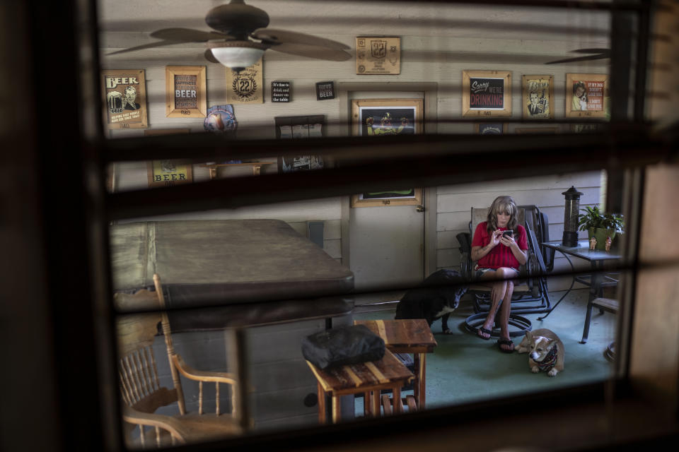 Barbie Rohde sits on her porch in Flint, Texas, Friday, June 9, 2023. Rohde is a conservative, a devoted fan of former President Donald Trump. She doesn’t like phrases like “gun control” and doesn’t believe in mandated gun restrictions. But something more needs to be done, she thinks. (AP Photo/David Goldman)