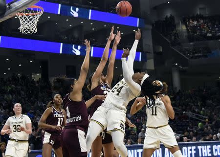 Mar 30, 2019; Chicago, IL, USA; Notre Dame Fighting Irish guard Arike Ogunbowale (24) shoots over Texas A&M Aggies guard Shambria Washington (4) during the second half in the semifinals of the Chicago regional in the women's 2019 NCAA Tournament at Wintrust Arena. Mandatory Credit: David Banks-USA TODAY Sports