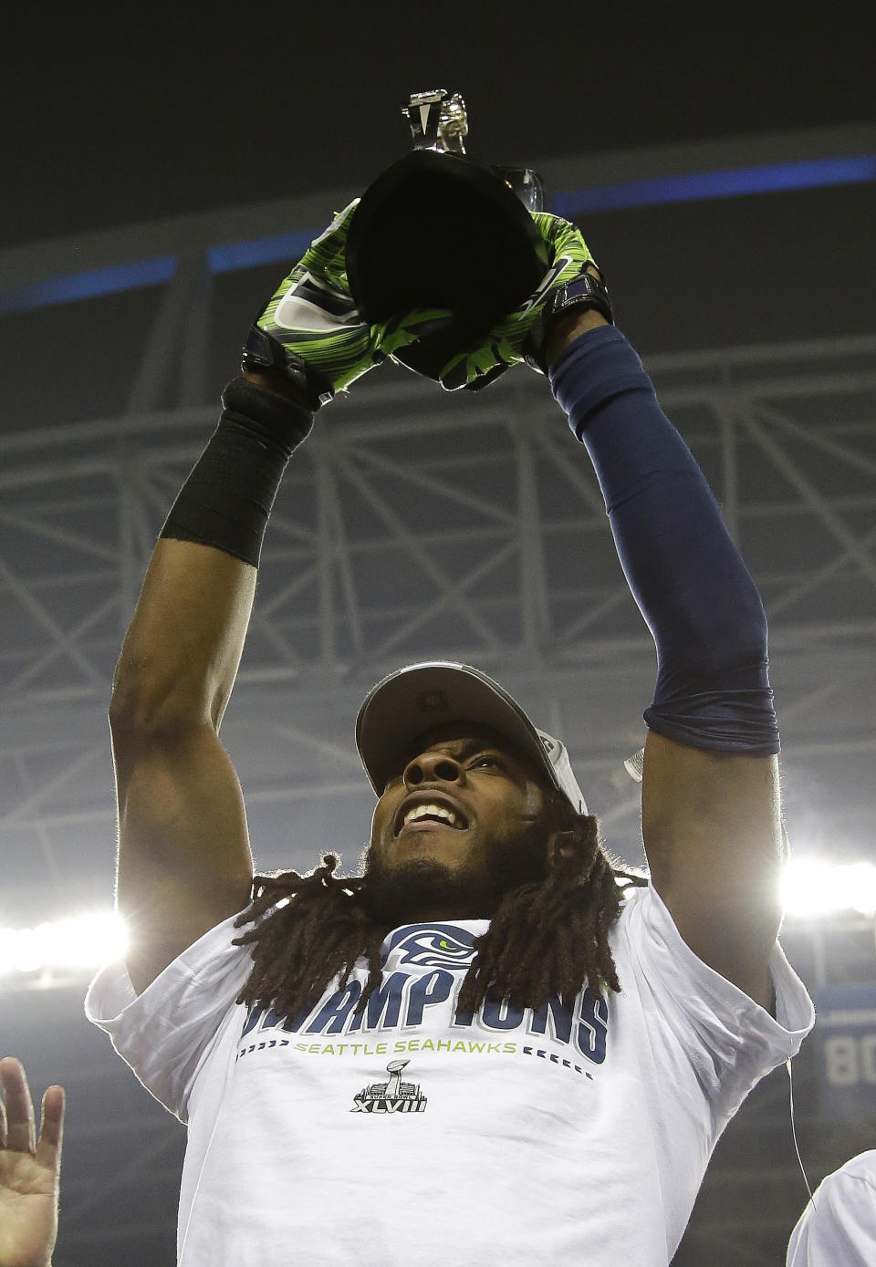 Seattle Seahawks' Richard Sherman holds up the George Halas Trophy after the NFL football NFC Championship game against the San Francisco 49ers Sunday, Jan. 19, 2014, in Seattle. The Seahawks won 23-17 to advance to Super Bowl XLVIII. (AP Photo/Matt Slocum)