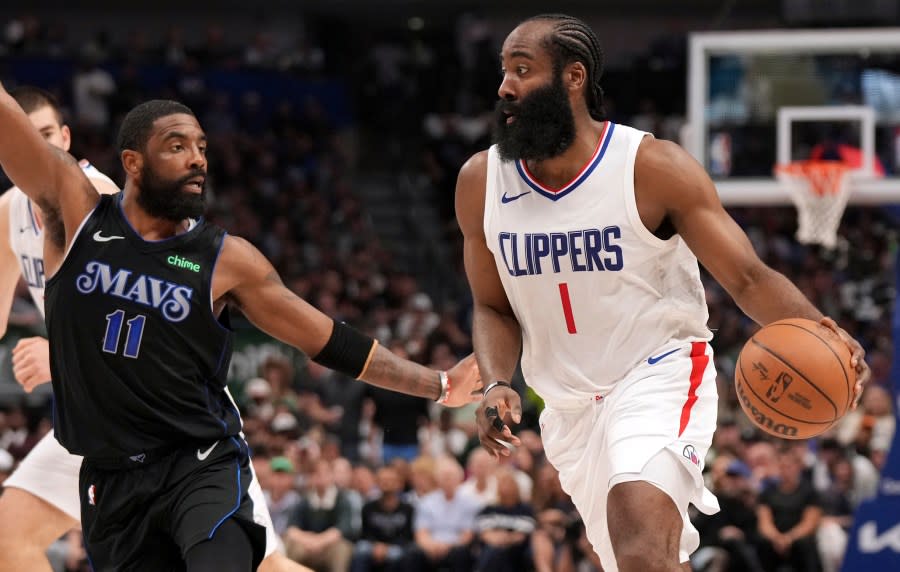 Los Angeles Clippers guard James Harden (1) drives against Dallas Mavericks guard Kyrie Irving (11) during the first half of Game 6 of an NBA basketball first-round playoff series Friday, May 3, 2024, in Dallas. (AP Photo/Jeffrey McWhorter)