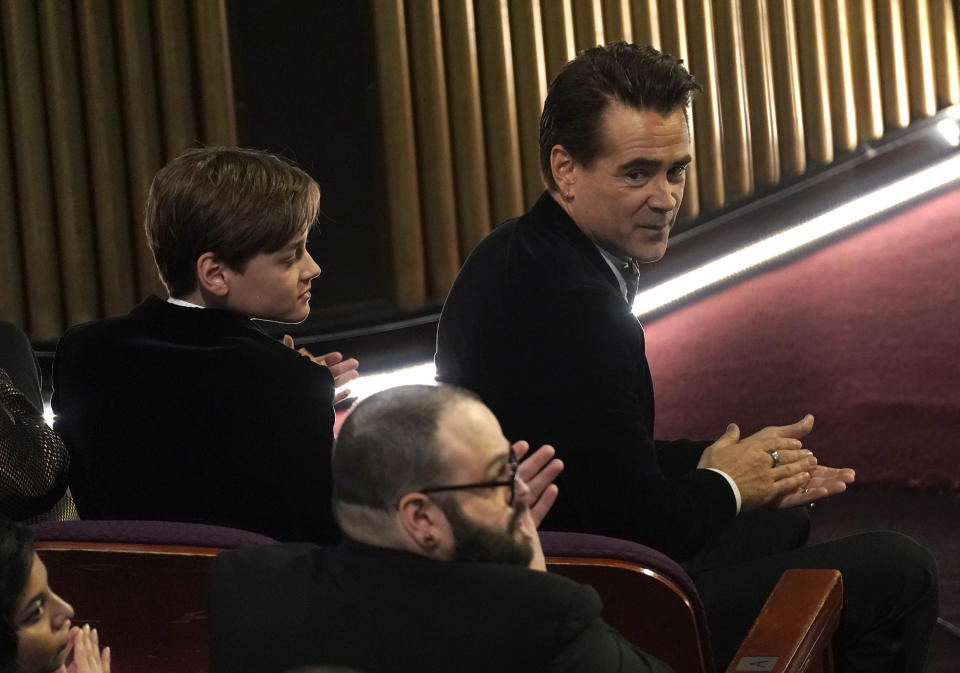 Colin Farrell, right, and Henry Tadeusz Farrell are seen in the audience at the Oscars on Sunday, March 12, 2023, at the Dolby Theatre in Los Angeles. (AP Photo/Chris Pizzello)