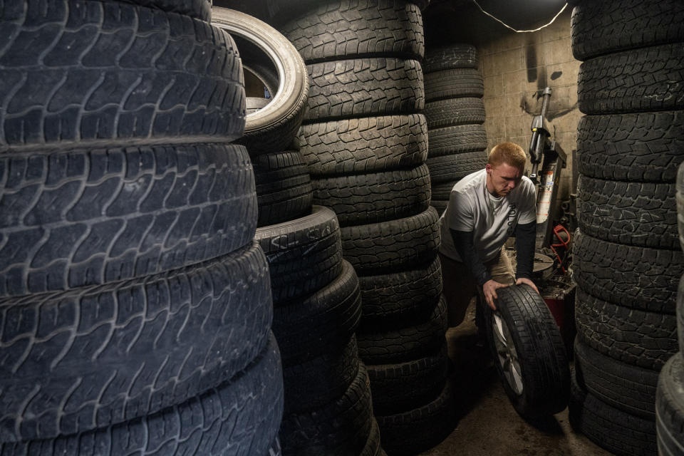 Steven Ash, 33, works at the tire shop his family owns in Huntington, W.Va., Wednesday, March 17, 2021, and where he overdosed just days before. Ash was 19 when he took his first OxyContin pill and his life spiraled after that. The last year has been particularly brutal. He took more drugs to numb the pain, but it made things worse, a vicious cycle, he said, but he isn't sure how to escape it. He knows he's putting his mother through hell. "I fight with myself every day. It's like I've got two devils on one shoulder and an angel on the other," he said. "Who is going to win today?" (AP Photo/David Goldman)