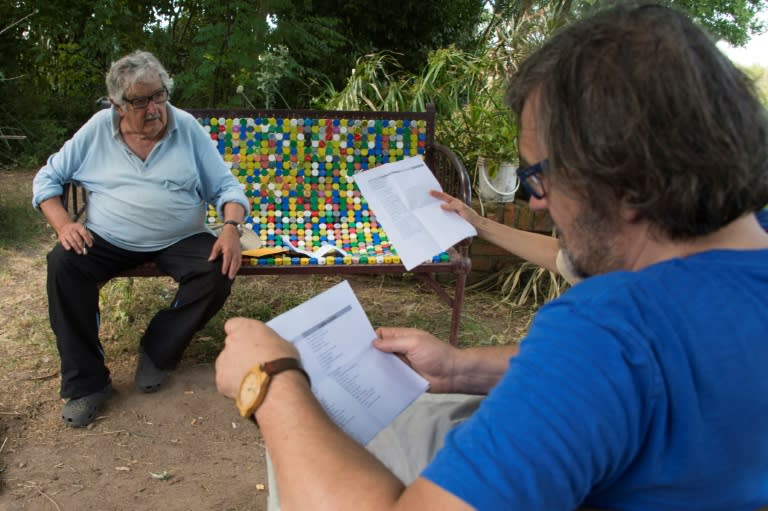 Uruguayan former president Jose Mujica (L) speaks during the shooting of an interview by director Emir Kusturica (R) at his home in Montevideo, in this picture taken in December 2016 -- the film is due to premiere at the upcoming Venice Film Festival