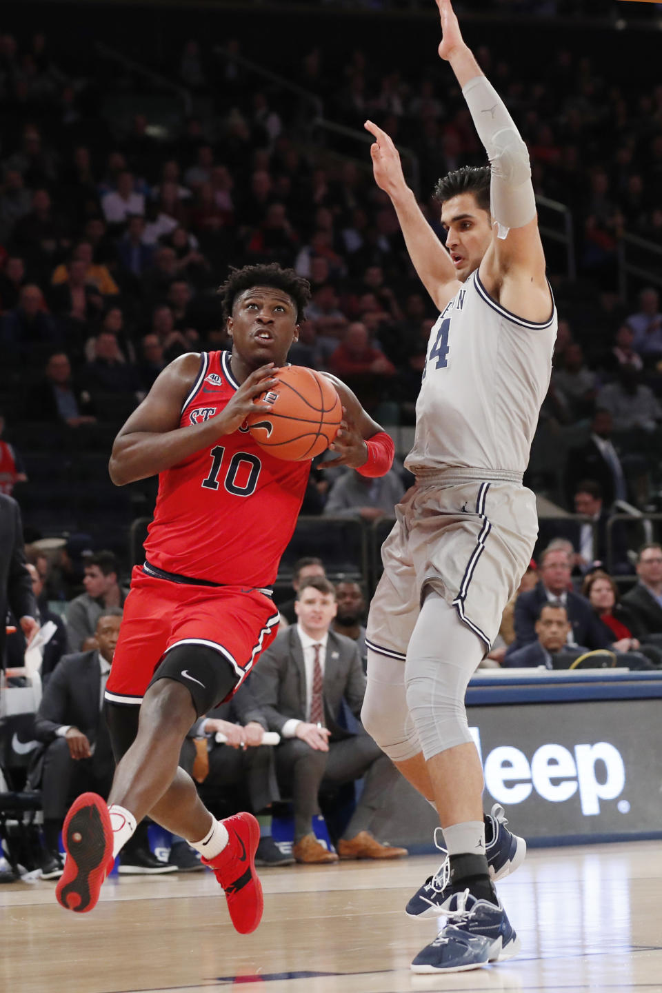 St. John's forward Marcellus Earlington (10) drives around Georgetown center Omer Yurtseven (44) during the second half of an NCAA college basketball game in the first round of the Big East men's tournament Wednesday, March 11, 2020, in New York. (AP Photo/Kathy Willens)