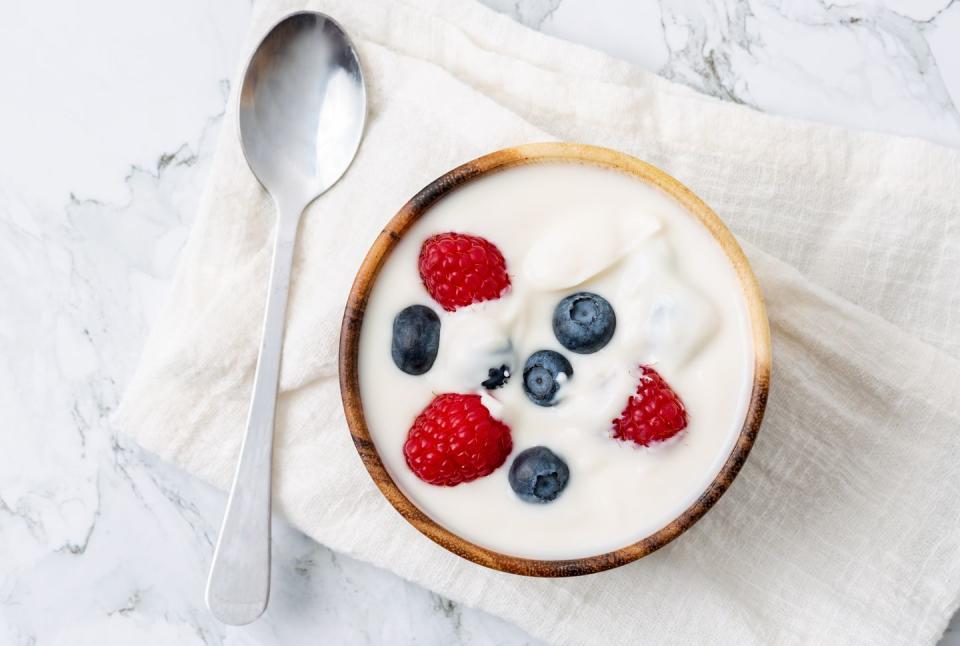 berry yogurt in a bowl and fresh blueberry, raspberry