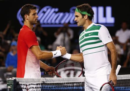 Switzerland's Roger Federer (R) shakes hands with Bulgaria's Grigor Dimitrov after Federer won their third round match at the Australian Open tennis tournament at Melbourne Park, Australia, January 22, 2016. REUTERS/Jason O'Brien