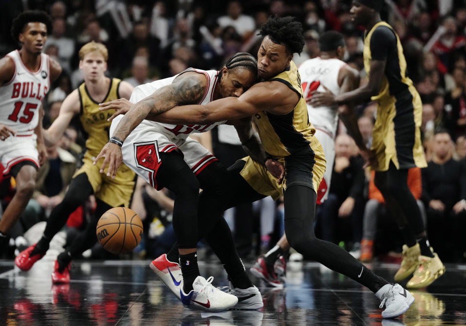 Toronto Raptors' Scottie Barnes, right, tries to steal the ball from Chicago Bulls' DeMar DeRozan during the second half of an NBA basketball In-Season Tournament game Friday, Nov. 24, 2023, in Toronto. (Frank Gunn/The Canadian Press via AP)