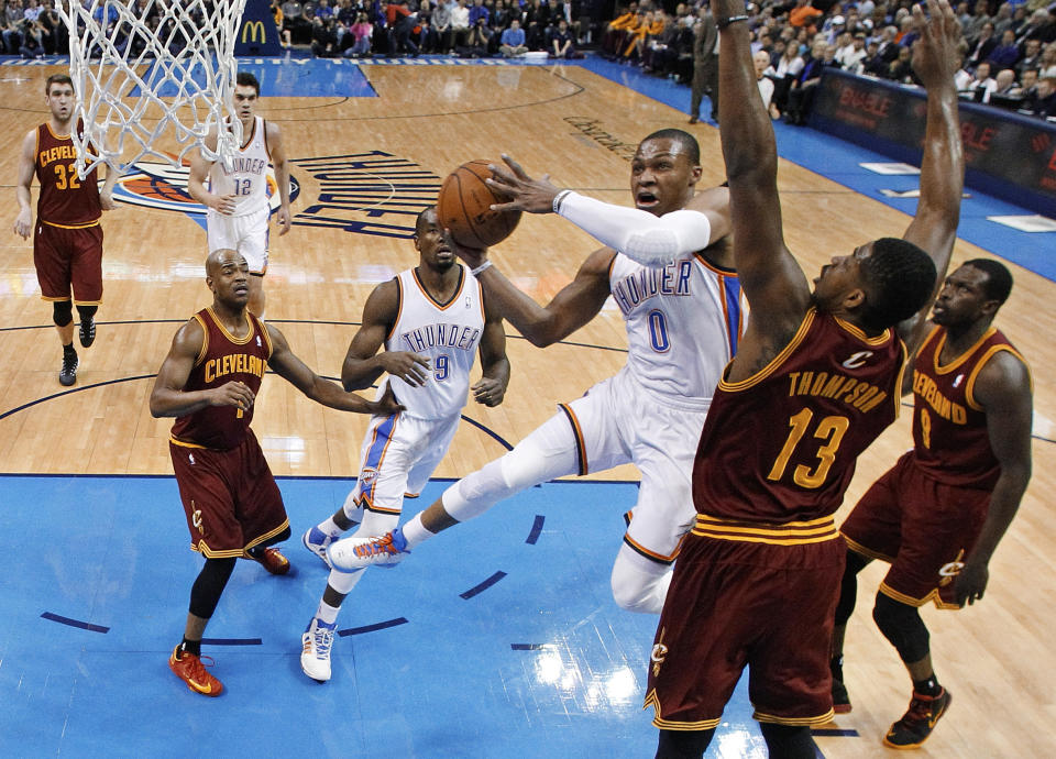 Oklahoma City Thunder guard Russell Westbrook (0) shoots in front of Cleveland Cavaliers forward Tristan Thompson (13) during the first quarter of an NBA basketball game in Oklahoma City, Wednesday, Feb. 26, 2014. Cleveland won 114-104. (AP Photo/Sue Ogrocki)