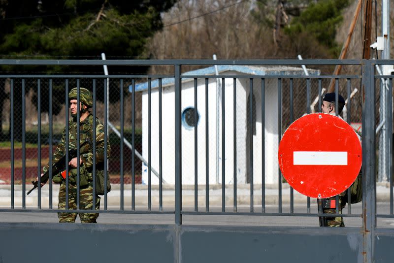 Greek soldiers stand guard at the closed Kastanies border crossing with Turkey's Pazarkule, in the region of Evros