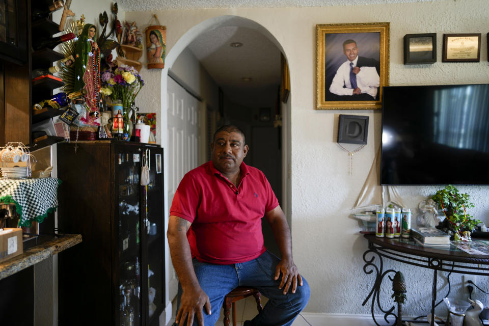 Jose Guerrero, a Mexican migrant who has lived in the U.S. since crossing the border as a teenager, first working in construction and now operating his own landscaping business, sits in the home he shares with his partner Rosalinda Ramirez, during an interview with AP journalists, in Homestead, Fla., Tuesday, Nov. 7, 2023. Across the country, politicians and others have been forceful advocates for newly-arrived migrants seeking shelter and work permits. Their efforts and existing laws have exposed tensions among immigrants who have been in the country for years, even decades, and don't have the same benefits, notably work permits. (AP Photo/Rebecca Blackwell)