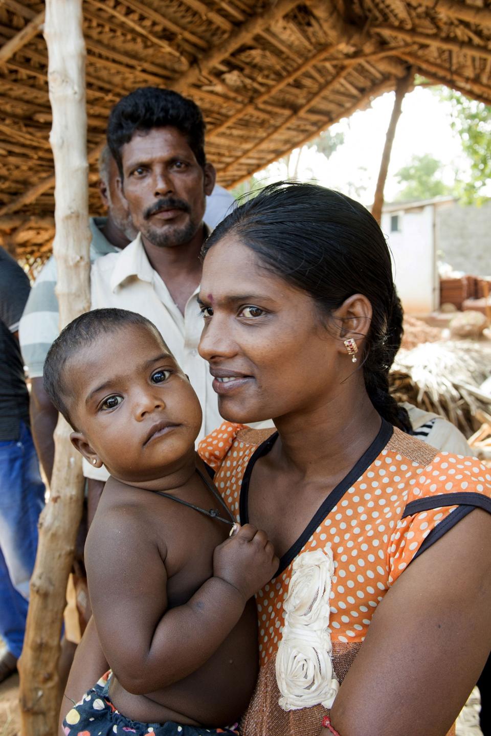 <p>Residents are seen in the resettlement area in Palau Veemankamam South Village in Jaffna District, Sri Lanka during Secretary-General Ban Ki-moon’s visit, where he toured a shelter run by the UN Refugee Agency (UNHCR); and latrines and well renovations administered by the UN Children Fund (UNICEF), Sept. 2, 2016. He also held a discussion with community representatives. The resettlement project was funded by the UN Peacebuilding Fund. (Photo: Eskinder Debebe/UN) </p>