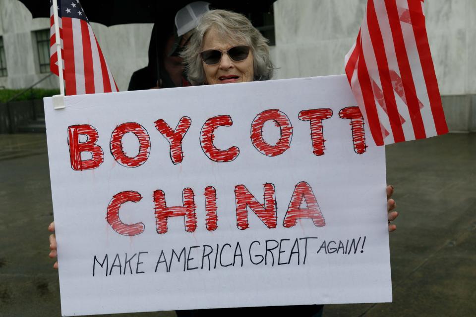 SALEM, OREGON, USA - MAY 2: A demonstrator holds a sign reading "Boycott China" during the protest at the State Capitol in Salem, Oregon, United States on May 2, 2020. Demonstrators protested Oregonâs economic-closure efforts aimed at minimizing the lethal impact of novel coronavirus (COVID-19). One of many rallies nationwide that have been linked to Republican and right-wing operatives of the Trump administration. (Photo by John Rudoff/Anadolu Agency via Getty Images)