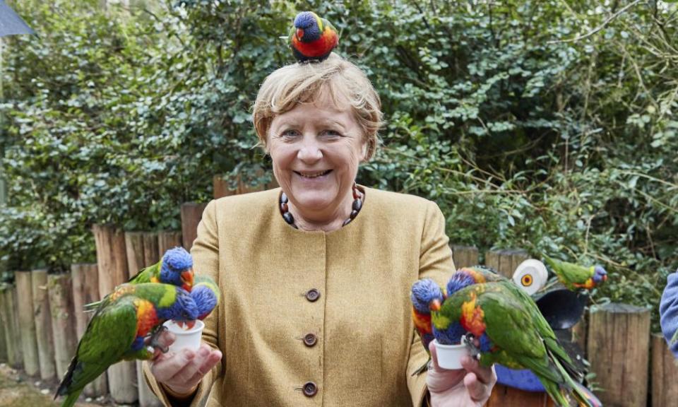 German Chancellor Angela Merkel feeds Australian lorikeets at Marlow Bird Park in Marlow, Germany.