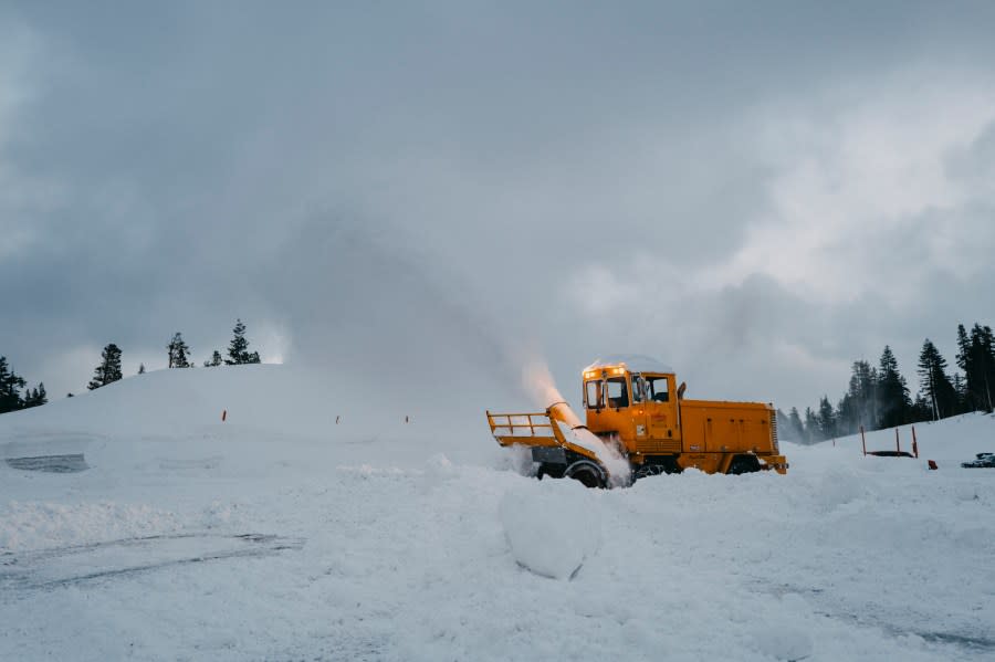 In this photo provided by the Mammoth Mountain Ski Area, a snow plow is used to clear snow in Mammoth Lakes, Calif., on Monday, Feb. 5 2024. (Hudson Henry/Mammoth Mountain Ski Area via AP)