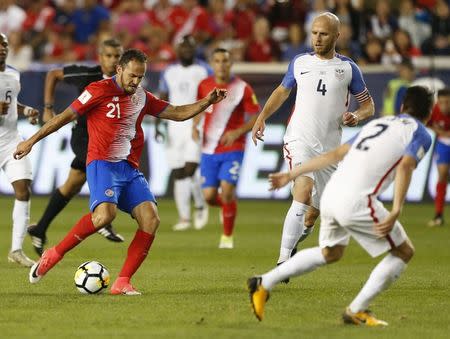 Sep 1, 2017; Harrison, NJ, USA; Costa Rica forward Marco Urena (21) dribbles the ball against United States defender Jorge Villafana (2) and midfielder Michael Bradley (4) during second half at Red Bull Arena. Costa Rica defeated USA 2-0. Noah K. Murray-USA TODAY Sports