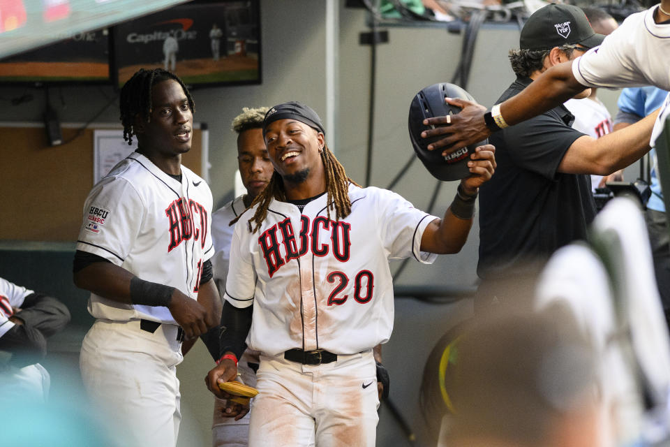Alabama State's Corey King (20) celebrates in the American League dugout after scoring during the second inning of the HBCU Swingman Classic baseball game during All-Star Week, Friday, July 7, 2023, in Seattle. (AP Photo/Caean Couto)