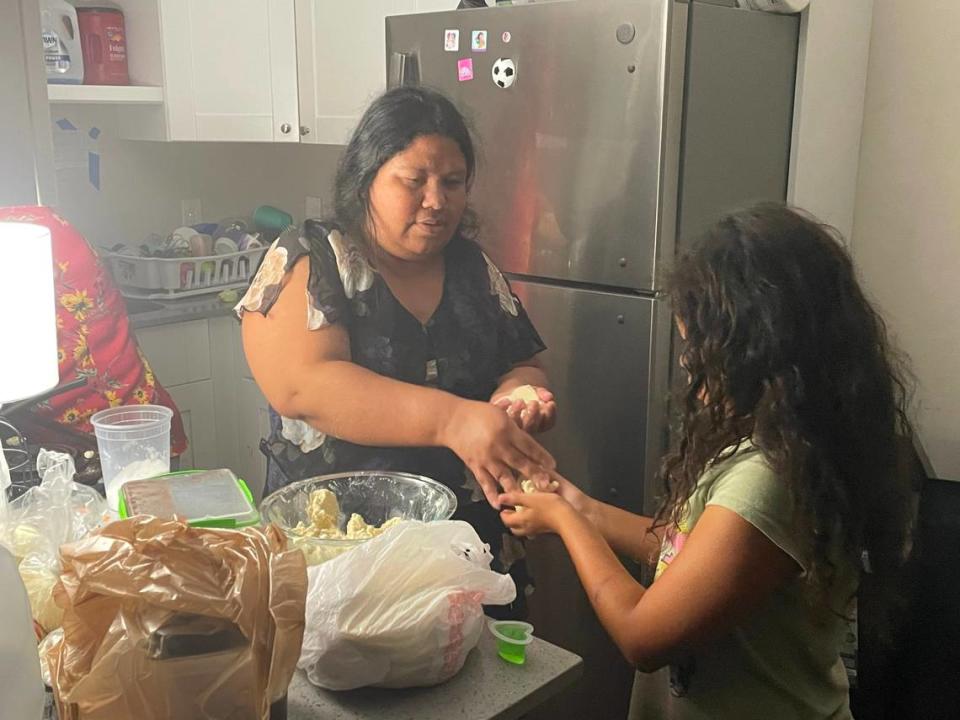 María Romero, 38, makes pupusas with her 8-year-old daughter in what is left of their River Park kitchen on the night of Friday, Sept. 30, 2022.