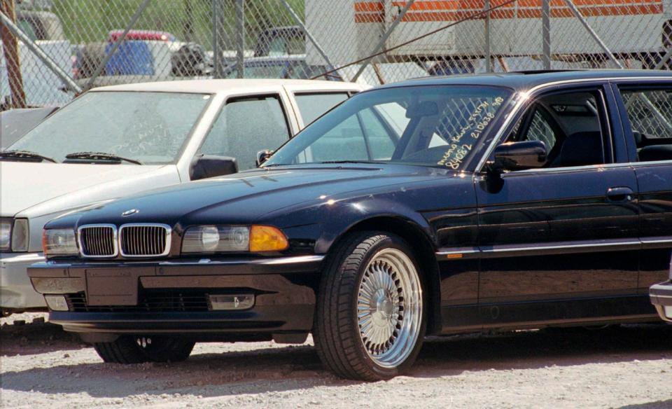 PHOTO: A black BMW, riddled with bullet holes, is seen in a Las Vegas police impound lot. Rapper Tupac Shakur was shot while riding in the car driven by Death Row Records chairman Suge Knight, Sept. 8, 1996. (Lennox Mclendon/AP)