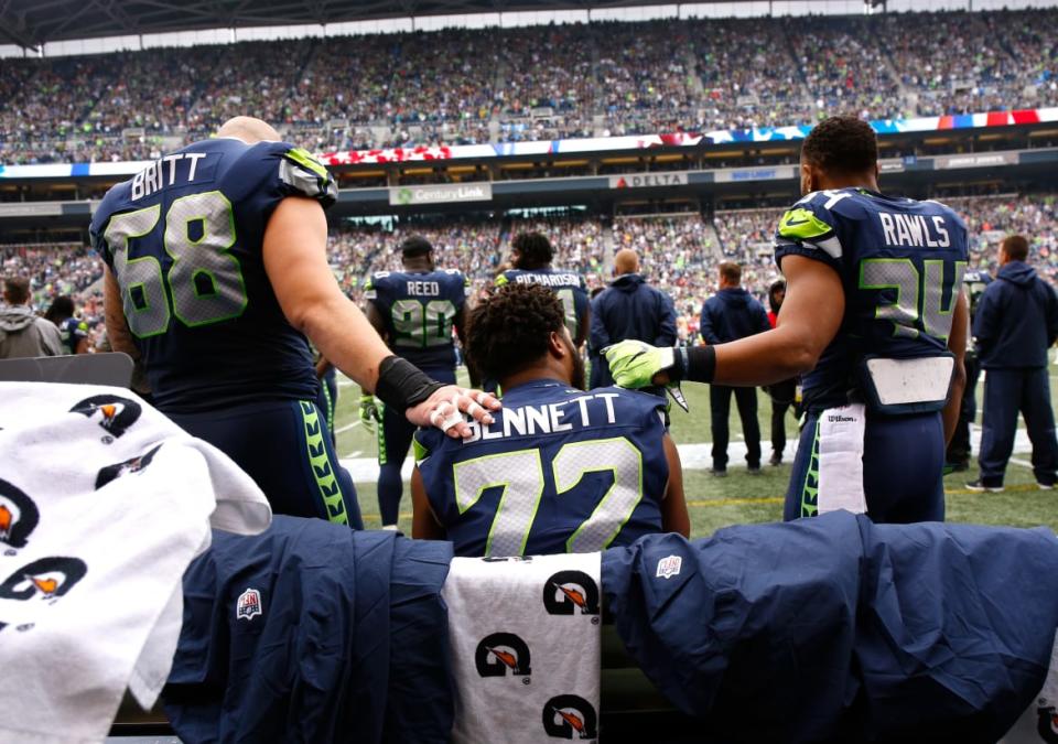 <div class="inline-image__caption"><p>Center Justin Britt #68 of the Seattle Seahawks (L) and running back Thomas Rawls #34 (R) join defensive end Michael Bennett #72 on the bench during the National Anthem before the game against the San Francisco 49ers at CenturyLink Field on September 17, 2017, in Seattle, Washington.</p></div> <div class="inline-image__credit">Otto Greule Jr/Getty</div>