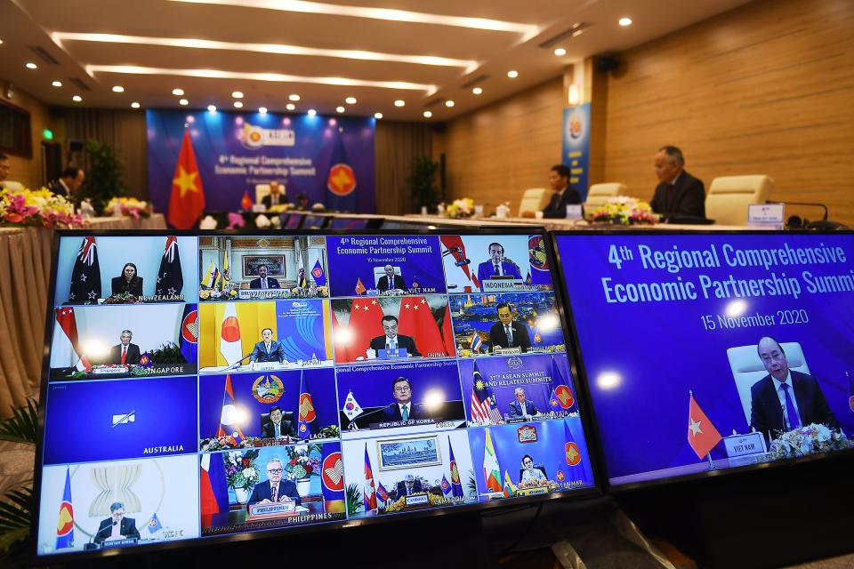 Vietnam's Prime Minister Nguyen Xuan Phuc is pictured on the screen (R) as he addresses his counterparts during the 4th Regional Comprehensive Economic Partnership (RCEP) Summit at the Association of Southeast Asian Nations (ASEAN) summit being held online in Hanoi on November 15, 2020. (Photo by Nhac NGUYEN / AFP) (Photo by NHAC NGUYEN/AFP via Getty Images)