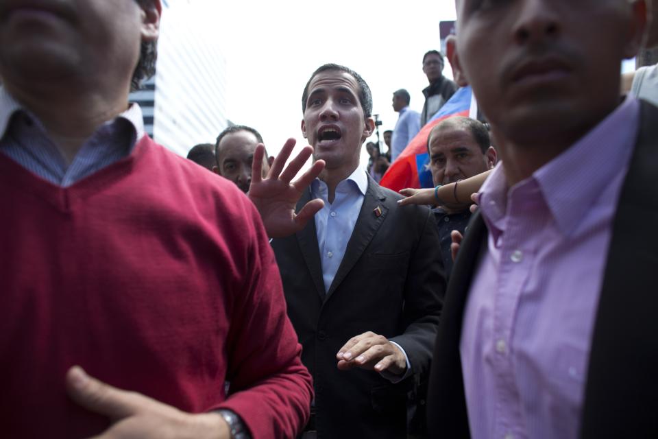 CORRECTS SPELLING OF GUAIDO - Venezuela's self-proclaimed interim president Juan Guaido walks into the crowd after he addressed transportation workers during a demonstration of support for him in Caracas, Venezuela, Wednesday, Feb. 20, 2019. Venezuela is gripped by a historic political and economic crisis despite having the world’s largest proven oil reserves. (AP Photo/Ariana Cubillos)