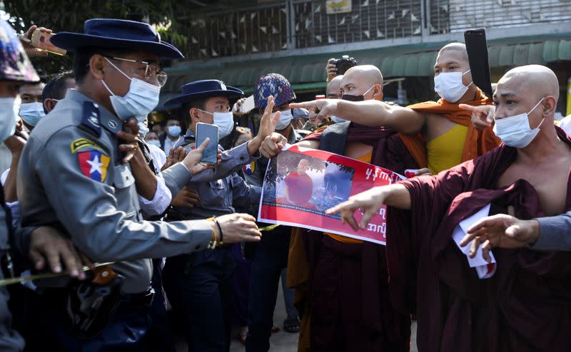 Police clash with Buddhist monks while they take part in a protest in support of the jailed nationalist right wing monk Wirathu outside Insein prison in Yangon