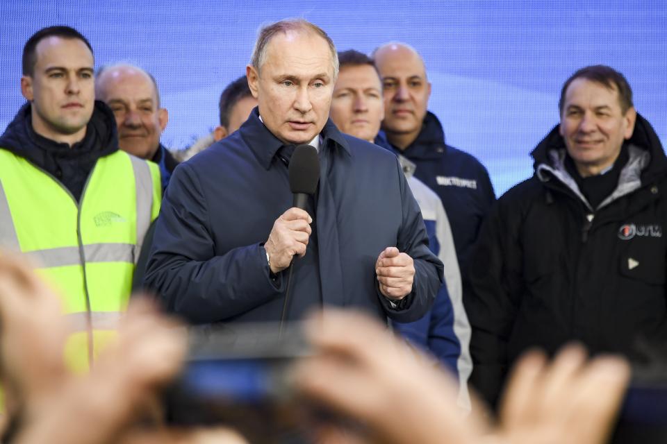 Russian President Vladimir Putin speaks to workers after riding a train across a bridge linking Russia and the Crimean peninsula in Taman, Russia, Monday, Dec. 23, 2019. Putin on Monday inaugurated a railway bridge to Crimea, the longest in Europe, which is intended to facilitate links with Crimea, which Russia annexed from Ukraine in 2014. (AP Photo)