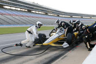 The team of Josef Newgarden makes adjustments and changes tires midway through through an IndyCar auto race at Texas Motor Speedway in Fort Worth, Texas, Saturday, June 6, 2020. (AP Photo/Tony Gutierrez)