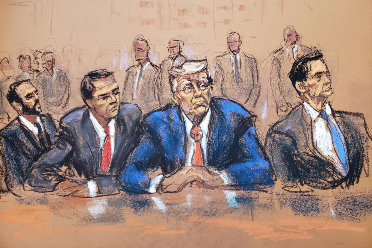 Former U.S. President Donald Trump pictured seated in court between Todd Blanche and John Lauro.