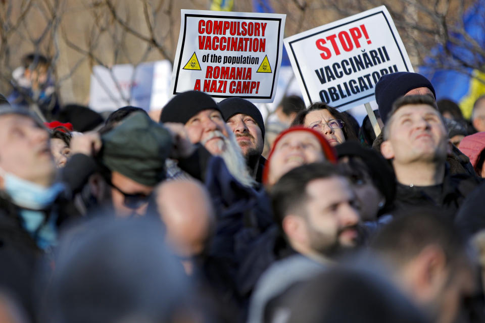 Anti-vaccination protesters rally outside the parliament building in Bucharest, Romania, Sunday, March 7, 2021. Some thousands of anti-vaccination protestors from across Romania converged outside the parliament building protesting against government pandemic control measures as authorities announced new restrictions amid a rise of COVID-19 infections. (AP Photo/Vadim Ghirda)