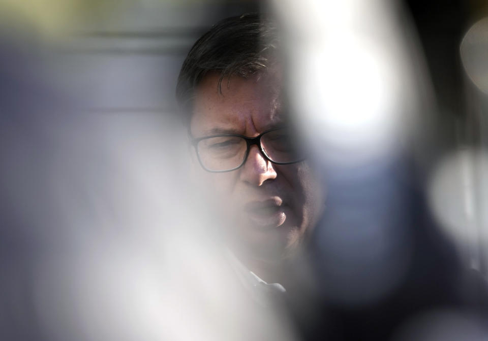 Serbia's President Aleksandar Vucic speaks to the media after casting his ballot for a referendum on constitutional changes, in Belgrade, Serbia, Sunday, Jan. 16, 2022. The government has said the amendments are designed to boost independence of the judiciary and are part of reform needed for Serbia's European Union membership bid. (AP Photo/Darko Vojinovic)