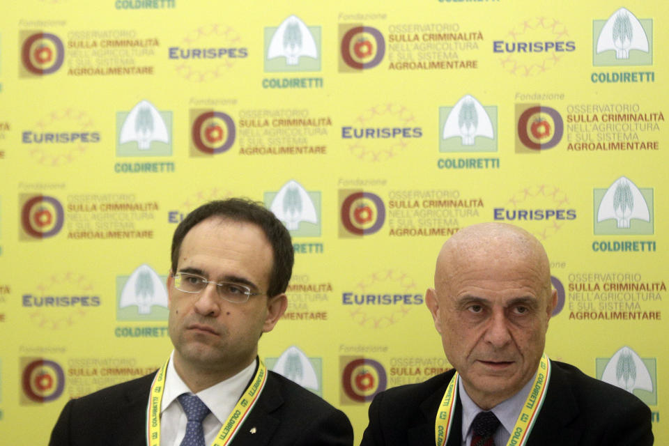 Italian Interior Minister Marco Minniti, right, and Coldiretti President Roberto Moncalvo present a report on organized crime infiltration in Italy's much prized food and agriculture businesses at the Coldiretti, the Italian farmers association headquarters in Rome, Tuesday, March 14, 2017. Organized crime has a seemingly insatiable appetite for farm and food businesses, one of the few economic sectors experiencing growth during Italy's protracted economic crisis. (AP Photo/Gregorio Borgia)