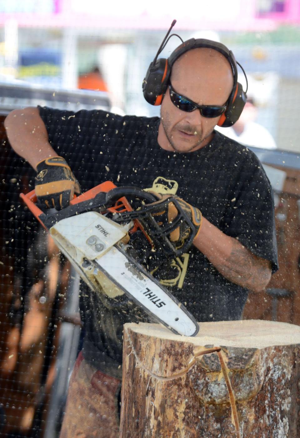 Chainsaw carver Adam Muholand from Sickline Carving in Windham, works on a wood carving during the opening day of the 157th Woodstock Fair on Friday September 1, 2017.