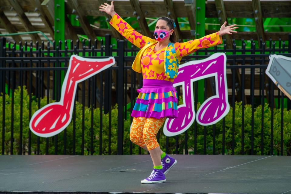 One of the performers dances and sings on stage during a job fair at Sesame Place in Langhorne.