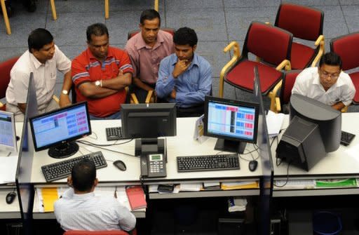 Share traders monitor prices at the Colombo Stock Exchange. Sri Lanka's stock market, once a darling of investors, has seen its value plummet 26 percent in the past year and now faces a crisis of confidence after its regulator quit in a storm of controversy