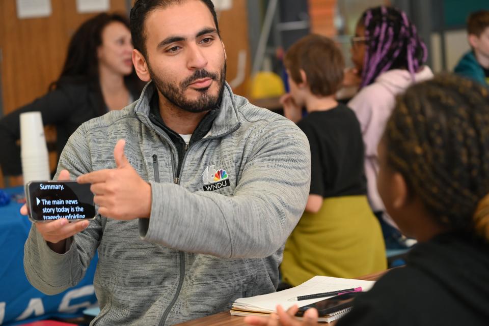 WNDU-TV's reporter Waleed Alamleh shows student, Tumariana, how to read a script from a prompter in the life of multimedia journalist on May 10, 2024 at 18645 Janet Drive.