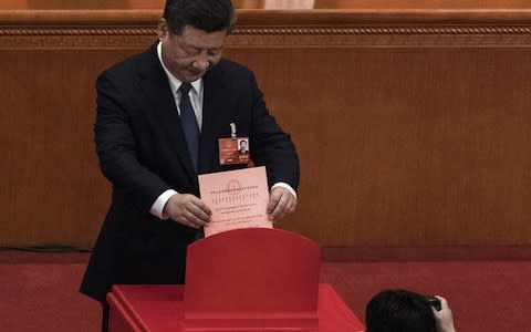 China's President Xi Jinping places his ballot in a box during a vote on an amendment to the constitution during a session of the National People's Congress at The Great Hall Of The People on March 11, 2018 in Beijing, China  - Credit: Getty Images