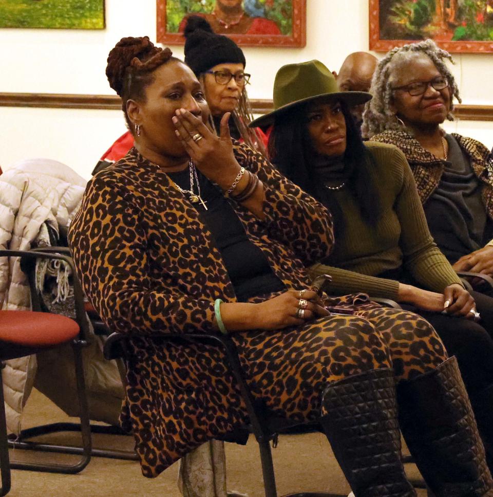 Sonja Dickenson weeps as Khalilah Camacho-Ali, Muhammad Ali's ex-wife, spoke at the Brockton Public Library on Saturday, March 4, 2023.