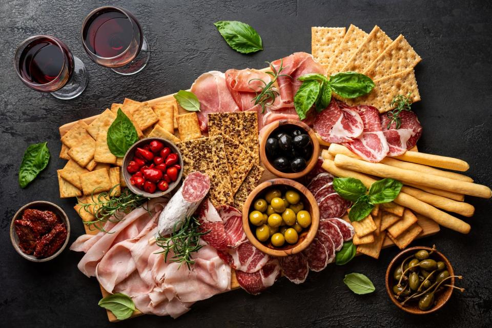 appetizers with differents antipasti, charcuterie, snacks and red wine sausage, ham, tapas, olives and crackers