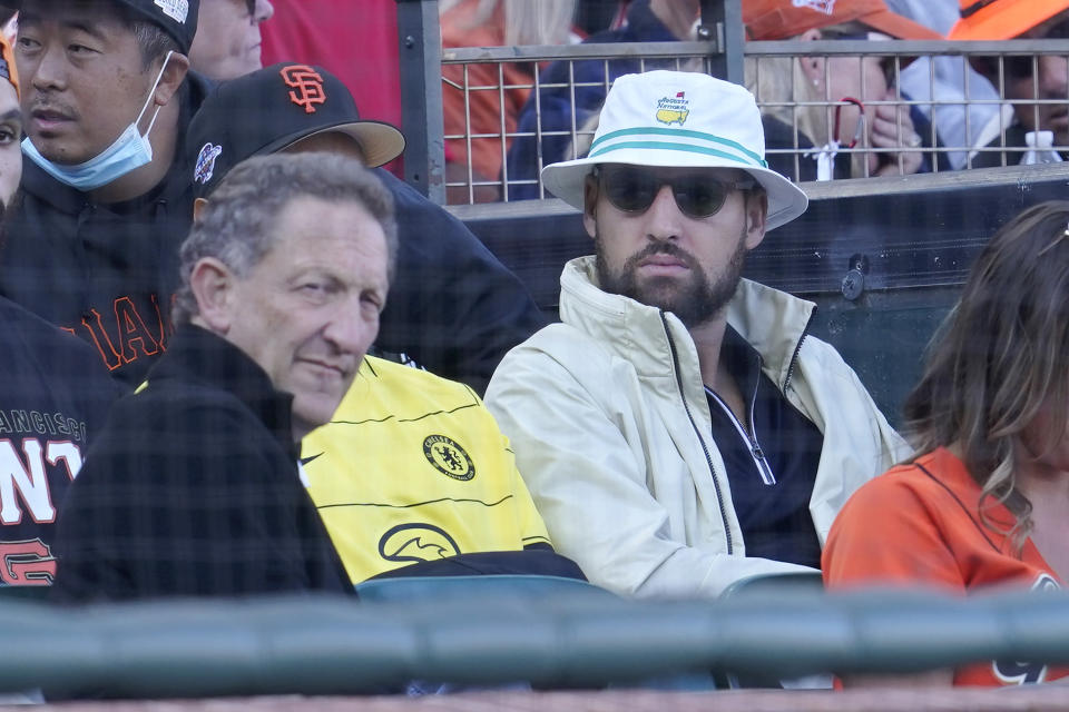 San Francisco Giants CEO Larry Baer, left, and Golden State Warriors basketball player Klay Thompson watch a baseball game between the Giants and the Los Angeles Dodgers in San Francisco, Sunday, Sept. 5, 2021. (AP Photo/Jeff Chiu)