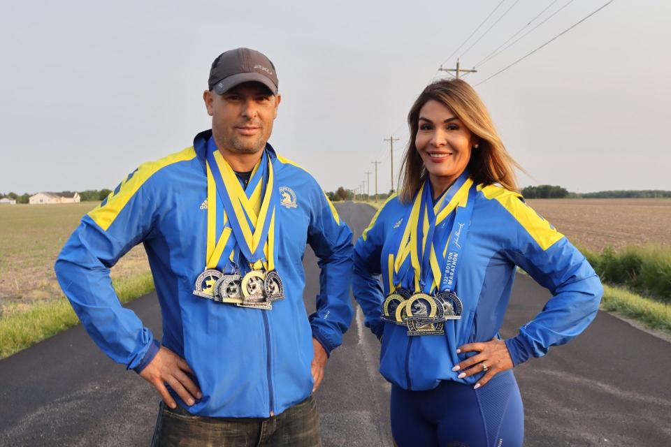 Jose Gaeta and Malena Salazar, two Lafayette athletes and business owners, pose with their 10 Boston Marathon medals.