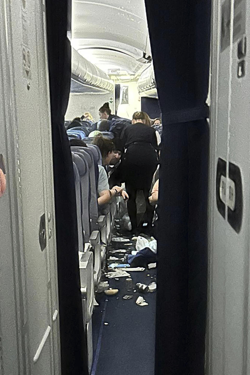 Food trays and other stuff are scattered inside the cabin as Lufthansa Flight 469 from Austin, Texas, headed to Frankfurt, Germany, that experienced “significant turbulence” and was diverted to Washington Dulles International Airport, Virginia, where it landed safely Wednesday, March 1, 2023. Crews responded to the flight and took seven people to hospitals with injuries that were believed to be minor. (Ecaterina Fadhel/via AP Photo)