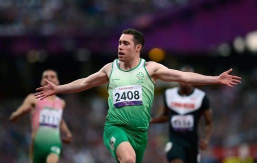 Ireland's Jason Smyth reacts as he crosses the finish line to win the Men's 100 metres T13 athletics final during the London 2012 Paralympic Games. Smyth retained his T13 100m title, breaking his own world record in the process to become the fastest Paralympian in history
