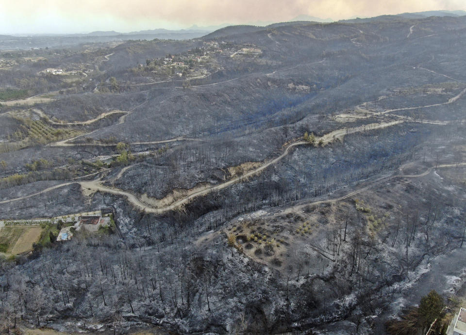 An aerial photo shows destroyed houses in a village as wildfire continue to rage the forests near the Mediterranean coastal town of Manavgat, Antalya, Turkey, Thursday, July 29, 2021. Authorities evacuated homes in southern Turkey as a wildfire fanned by strong winds raged through a forest area near the Mediterranean coastal town of Manavgat. District governor Mustafa Yigit said residents of four neighborhoods were moved out of the fire’s path as firefighters worked to control the blaze that broke out Wednesday. It was not immediately clear what caused the fire but authorities said nearby tourist resorts were not affected. (Suat Metin/IHA via AP)