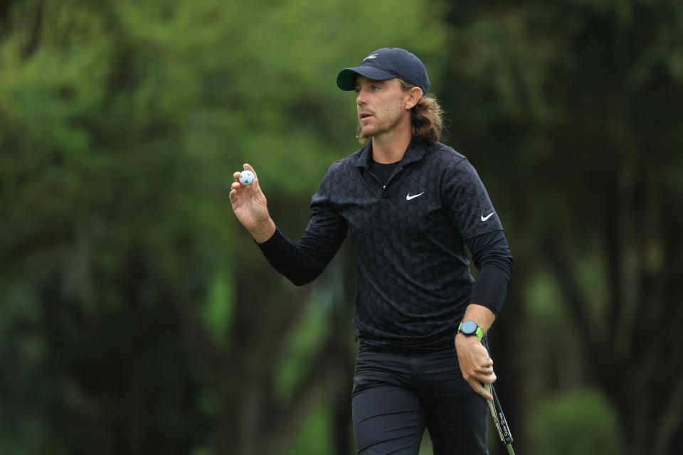 Seen here, England's Tommy Fleetwood waves after putting on the third green during the first round of The Players Championship in Florida. 