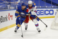 Buffalo Sabres forward Taylor Hall (4) and New York Rangers defenseman Pavel Buchnevich (89) battle behind the net during the second period of an NHL hockey game, Tuesday, Jan. 26, 2021, in Buffalo, N.Y. (AP Photo/Jeffrey T. Barnes)