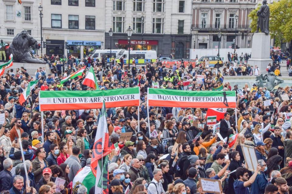 protesters hold iranian flags, and 